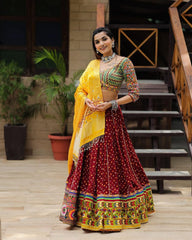 Gamthi Border Print With Bandhani Maroon Lehngha Choli With Mirror Work And Attached Yellow Dupatta